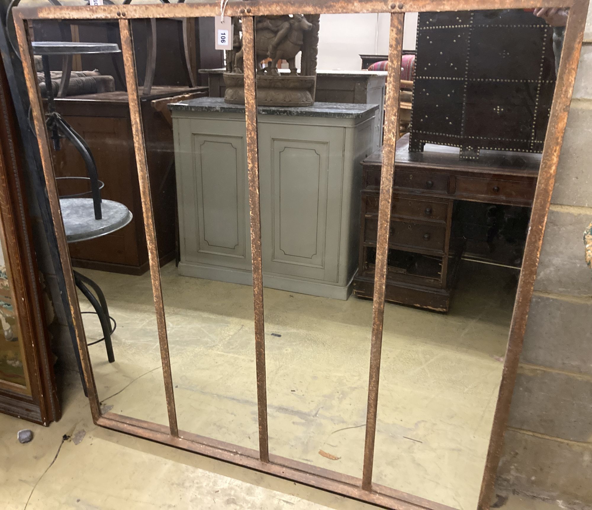 An industrial style metal framed wall mirror, width 131cm, height 135cm